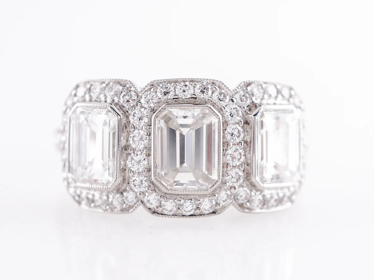 Deco Style Three Stone Emerald Cut Diamond Ring in Platinum